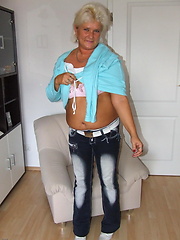 Aged white-haired mom demonstrating her busty naked body