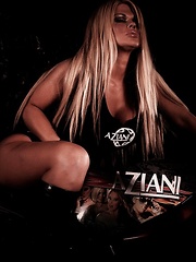 Busty blonde bombshell, Sophia Rossi, shows off her generous curves posing with the Aziani motorcycle in her tank top and shorts. Even better is when she takes it all off!